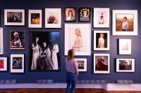 Woman in a gallery looking at pictures