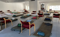 a room full of beds and chairs to host refugees