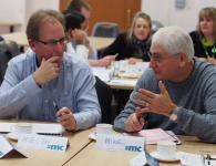 Photo of two men in discussion in workshop