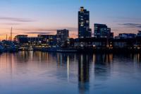 Southampton skyline in the evening. The buildings are reflected on body of water.