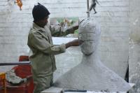 Man working on his sculpture