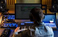 Man produce electronic music in studio stock photo