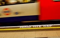 Underground station platform showing words 'mind the gap'