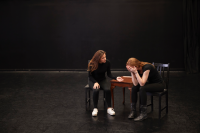 two drama students rehearse on a stage