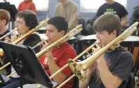 Photo of young people practicing trombone