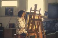 A woman painting in an art studio