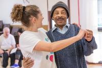 Photo of woman in dance hold with older man