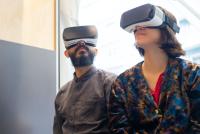 A man and woman wearing virtual reality headsets
