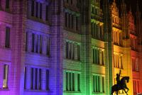 A building bathed in rainbow-coloured light