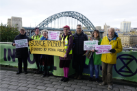 Protesters from XR North East holding placards that say 'Science Museum funded by fossil fuels'