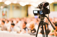 a recording camera films a conference