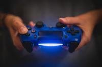 Photo of person holding a video game controller