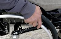 Photo of hand on a wheelchair wheel