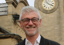 Gordon Seabright, a man with short grey hear wearing glasses and smiling