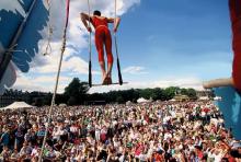 Image of trapeze artist at outdoor festival