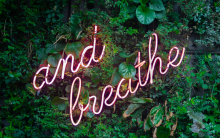 neon sign reading 'and breathe'