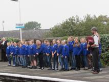 Image of children singing on railway platform