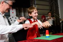 Photo of child doing trick with cups