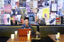 Photo of woman with laptop in cafe