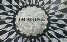 black and white mosaic pavement with the word 'Imagine' set in black