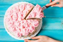 Photo of a pink cake being sliced
