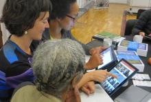 Photo of three women looking at tablets