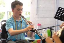 A young person playing a clarinet