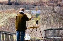 Photo of a man painting outside
