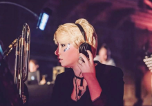 Rhiannon Harrison in an orchestra pit wearing headphones
