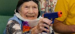 Photo of old woman holding a gun
