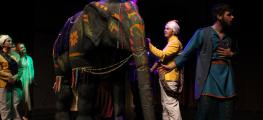 Actors and elephant puppet on stage