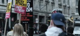 rear view of protestors on an anti racism march holding banners