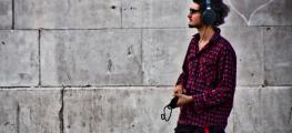 Photo of man on street with headphones