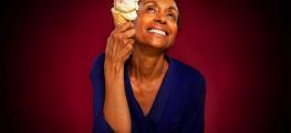 Photo of a woman holding an ice cream staring towards the ceiling