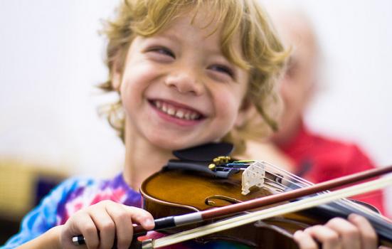 Photo of young boy playing the violin