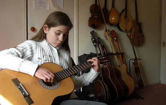 Photo of child playing guitar