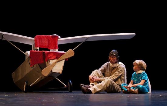 Photo of man and boy on stage with aeroplane