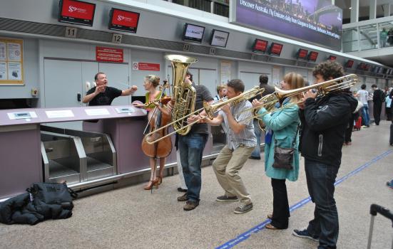 Brass instruments play at check-in.