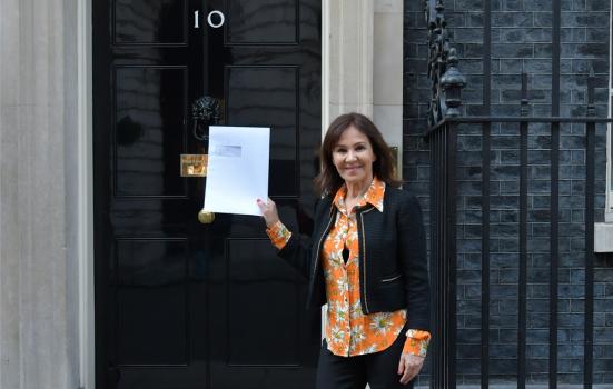 Photo of Arlene Phillips outside Number 10 with letter
