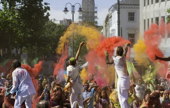 Photo of people throwing coloured powder