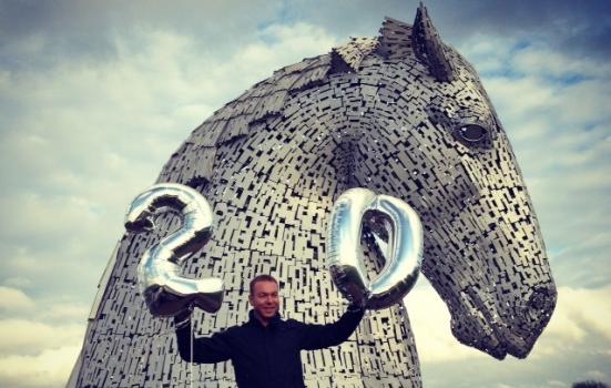 Photo of Chris Hoy standing in front of The Kelpies sculpture