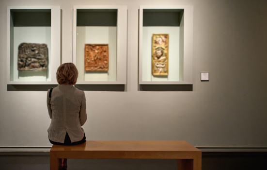 Woman looks at items in an exhibition