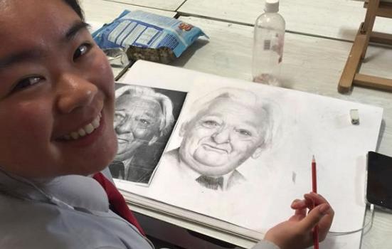 Girl doing a pencil sketch from a model