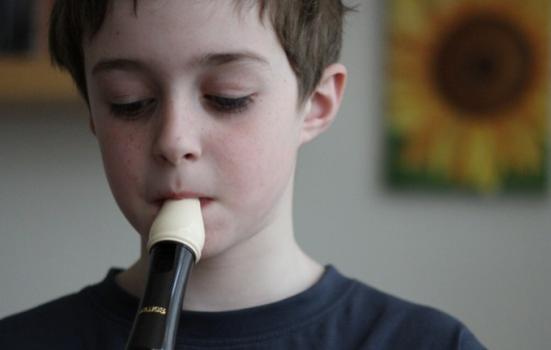 Photo of a boy playing a recorder