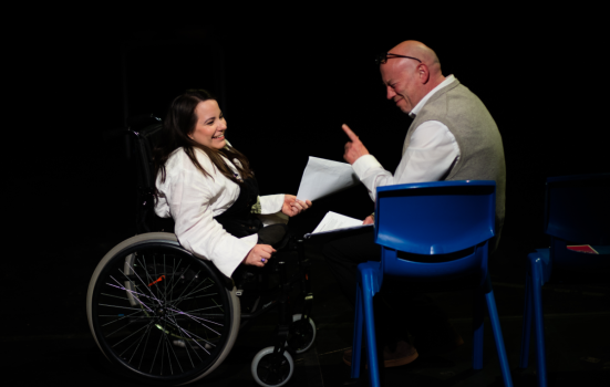 Image of a man and woman (in a wheelchair)