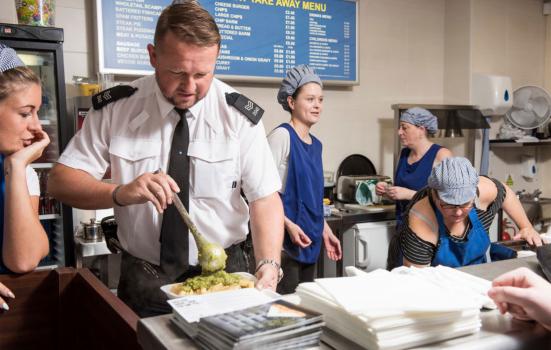 A photo of a member of Merseyside Police force working in a local chip shop