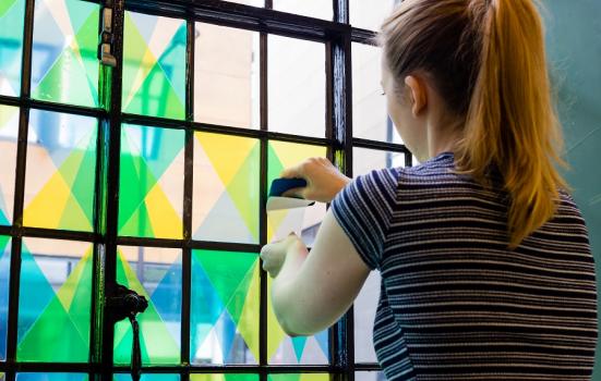 Artist working on coloured window