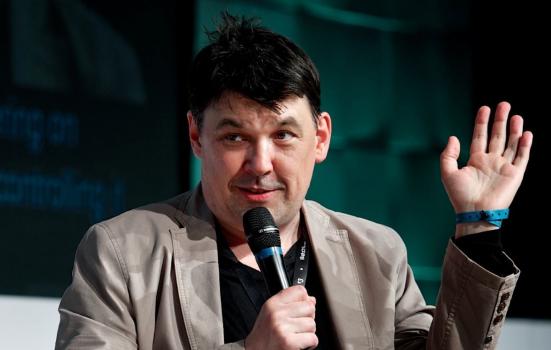 Graham Linehan speaking on stage at an event