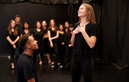 Male and female drama students at a performing arts school In studio improvisation class