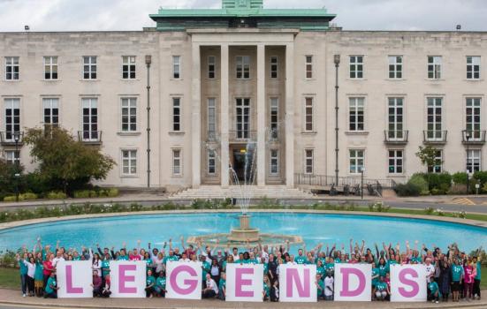 Photo of large building with people holding legends banner